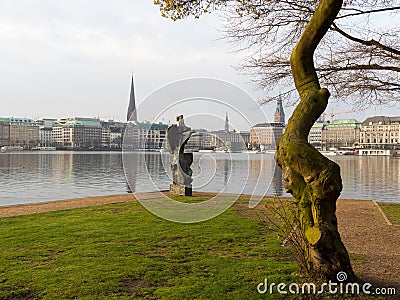 View at tree and sculpture named Windsbraut, whirlwind and Binnenalster and Jungfernstieg in Hamburg, Germany. Editorial Stock Photo