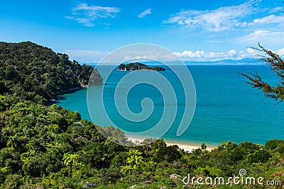 A view through the trees of a beach at the incredibly beautiful Able Tasman National Park, South Island, New Zealand Stock Photo