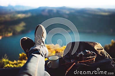 View trekking feet tourist backpack photo camera in auto on background panoramic landscape mountain, vacation concept, foot photo Stock Photo