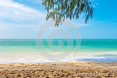 View from tropical beach at Koh Lanta island, Thailand. View to pure sea with boats and yacht on water. Look from shadow of tree Stock Photo