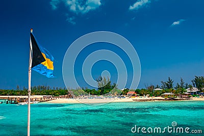 View on the tropical island in Bahamas with the national Bahama flag. Stock Photo