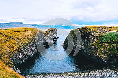 View trough the cliffs near Gatklettur, Iceland. Stock Photo