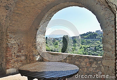 A view trough a stone arch window Stock Photo