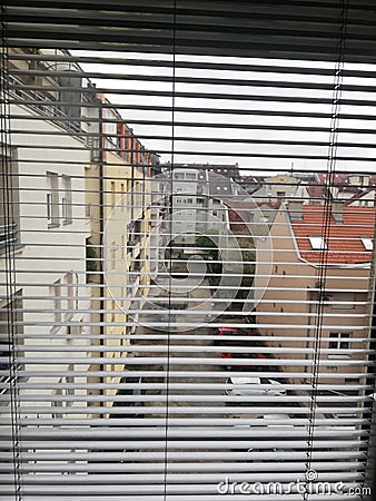 View trough venetian blind. View through jalousie outwards. Stock Photo