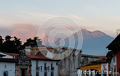 View of two volcanoes, Fuego and Acatenango, illuminated by a golden sunrise in Guatemala Stock Photo