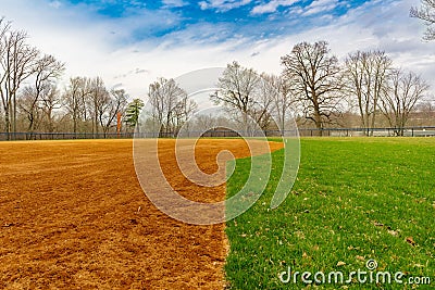 View of typical nondescript high school softball field with clay infield Stock Photo