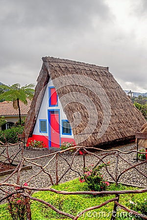 view of typical traditional house in Santana, Madeira, Portugal, Atlantic ocean during rainy day Stock Photo