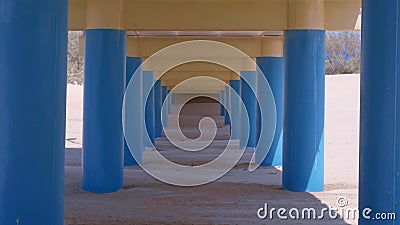 View Under The Bridge On Sand Beach Parallel Blue Columns Hold