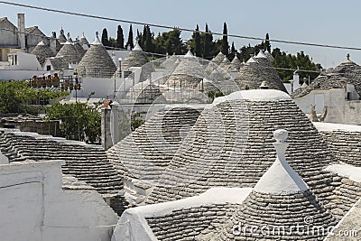 View on the unique limestone roofs of the cone-shaped houses in Alberobello, Apulia, Italy. Editorial Stock Photo