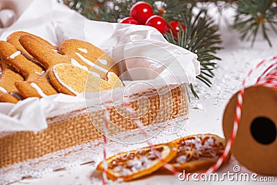 View of the unpacked christmas present with sweets against the background of a spruce branch Stock Photo