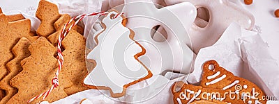 View of the unpacked christmas present with sweets inside white paper packaging, banner, close-up Stock Photo