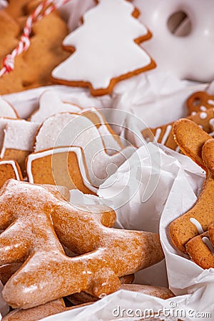 View of the unpacked christmas present with sweets inside white paper packaging with selective focus Stock Photo