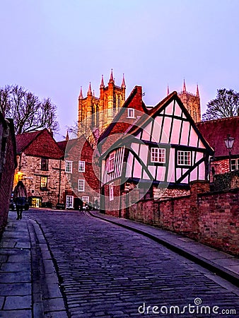 A view up Michaelgate in Lincoln City centre at Sunset with Lincoln Cathedral in the background. December 2019. Editorial Stock Photo