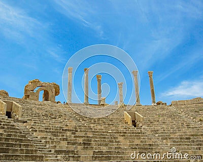 Stairs, viewing stands and columns against blue sky at ancient Roman theater of Leptis Magna in Libya Stock Photo