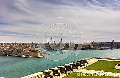 View on Valletta Grand harbor from the historic Upper Barraka garden area in Malta with historic line of cannons-Saluting Battery Stock Photo