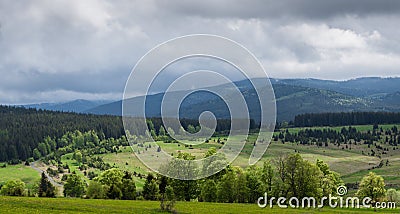 A view of the valley illuminated by a sunlit under cloudy sky Stock Photo