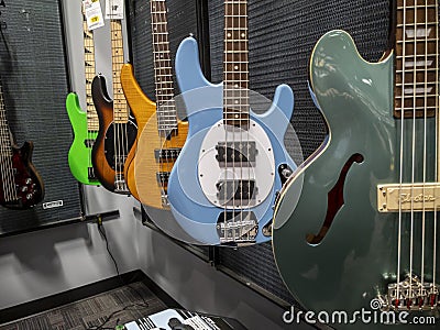 Lynnwood, WA USA - circa May 2022: View of various bass guitars for sale inside a Guitar Center musical instrument store Editorial Stock Photo