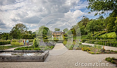 View of the vegetable and formal gardens with fountains in front of the luxury Hotel at The Newt, near Bruton, Somerset, UK Editorial Stock Photo