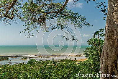 View from a viewpoint, contemplating the sea, a small river and lots of vegetation, all under a beautiful blue sky. Stock Photo