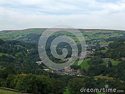 View of the village of cragg vale in the calder valley surrounded by trees and fields Stock Photo