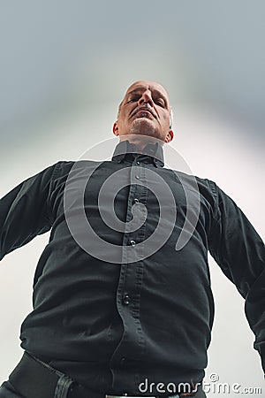 View from waist level looking up at a senior man with goatee Stock Photo