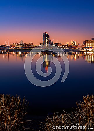 View of the warm pink sunrise over the modern skyline of Louisville KY reflected on the river water Editorial Stock Photo