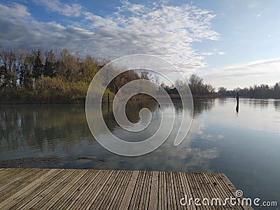 view of the water of a river, with reflection of trees and Sky Stock Photo