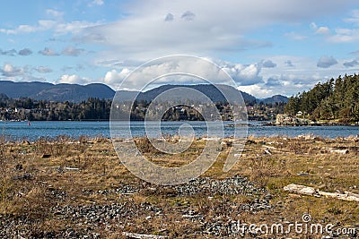 View of water and seaside town in mountains Stock Photo