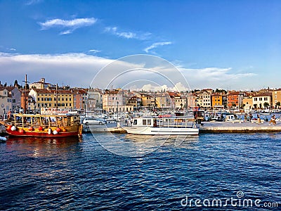 A view of the waterfront of Rovinj, Croatia full of colourful old buildings and boats docked in the bay. Editorial Stock Photo