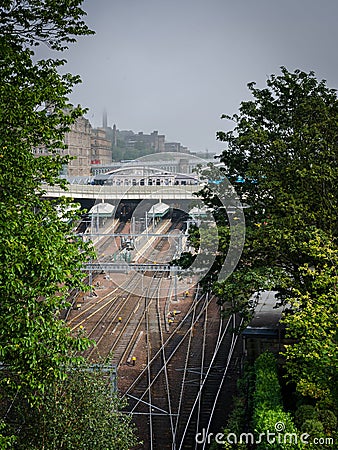 View of Waverley station among the trees in Edinburgh on a foggy day, Scotland Stock Photo