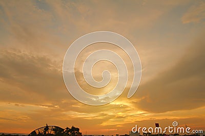 View of the weather in the evening, looking at the sun and the orange-yellow sky Stock Photo