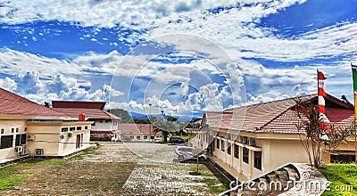 The view of white and blue clouds adorns the beauty of the Rasiei office building, teluk wondama regency, west papua province Editorial Stock Photo