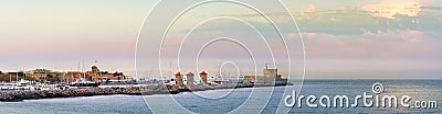 View of the Windmills and the lighthouse at Mandraki Harbour, Rhodes, Greece Stock Photo