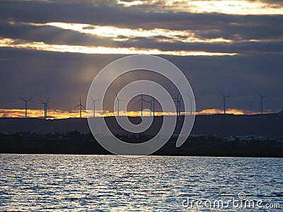 View of the windmills wind turbines near salt lake near Larnaka durign sunset winter holiday Stock Photo