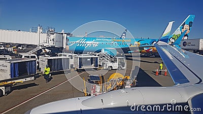 Busy airport jetway gate with airplanes loading-unloading Editorial Stock Photo