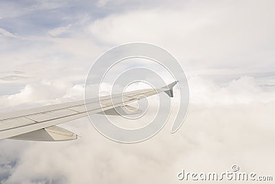 Aerial view of wing from jetplane blue sky and big white cloud background Stock Photo