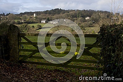 View through wooden gate of church in distance Dar Stock Photo