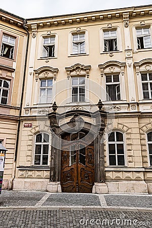 View of a wooden ornamented door in a street in Prague Editorial Stock Photo