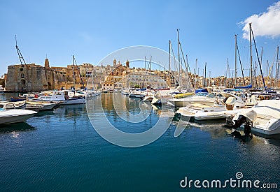 The view of yachts moored in harbor in Dockyard creek with Senglea peninsular on background. Malta Stock Photo