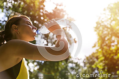 View of young woman running on sidewalk in morning. Health conscious concept Stock Photo