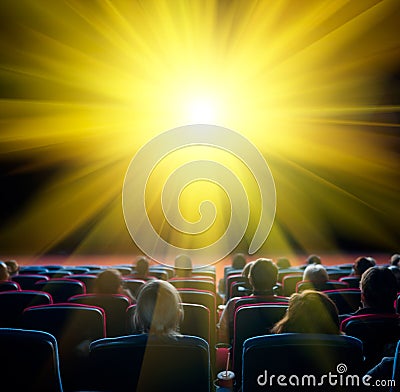 Viewers look at shining sun in cinema Stock Photo