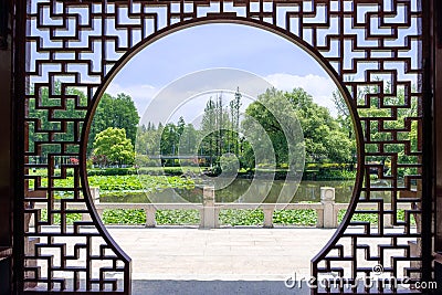 Viewing the Lotus Pond from the Chinese style Full Moon Gate Stock Photo