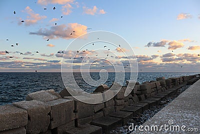 Views of the Fuengirola dike in the harbor at sunset Stock Photo