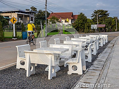 Views of rows of white marble tables and chairs lined up on the paved stone floor paved a way Stock Photo