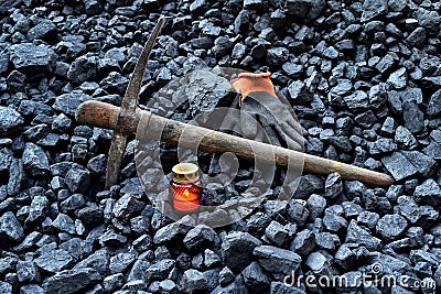 Vigil light, candle with the miner belongings gloves, pickaxe Stock Photo