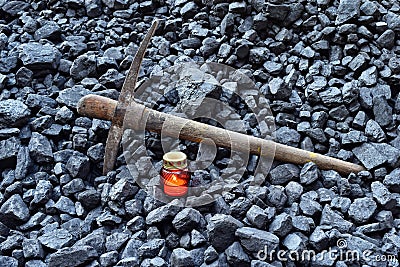 Vigil light, candle with the miner pickaxe Stock Photo