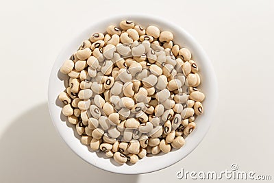 Black Eyed Pea legume. Top view of grains in a bowl. White background Stock Photo