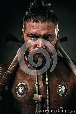 Viking with cold weapon in a traditional warrior clothes Stock Photo