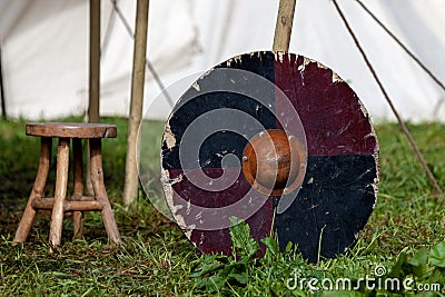 Viking shield leaning against a tent peg Stock Photo