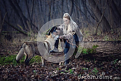 Viking warrior female with a wolf in the forest - Cinematic medieval scene Stock Photo